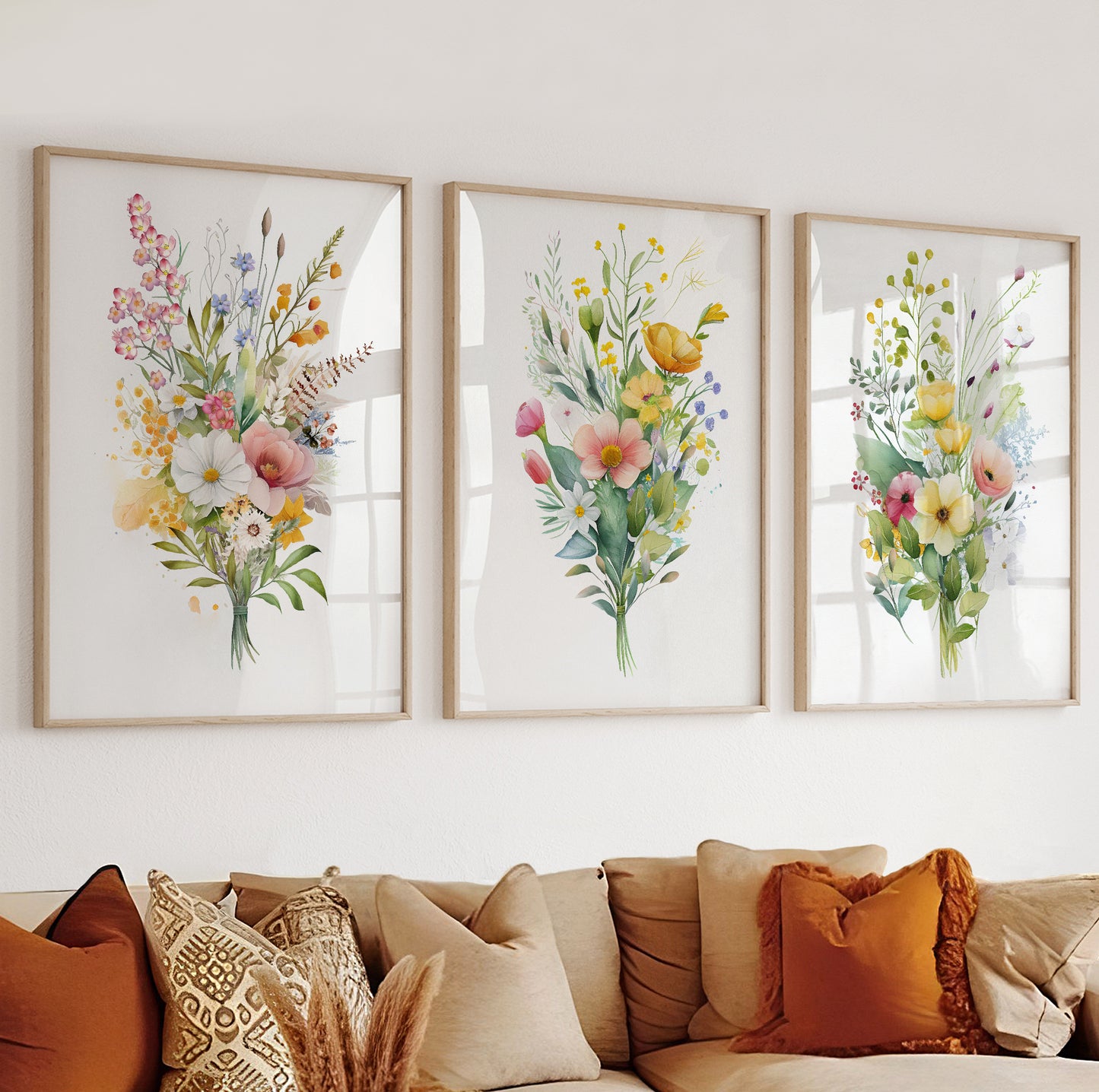 Botanical wall art with pink, yellow, and blue flowers arranged in a soft watercolor composition.