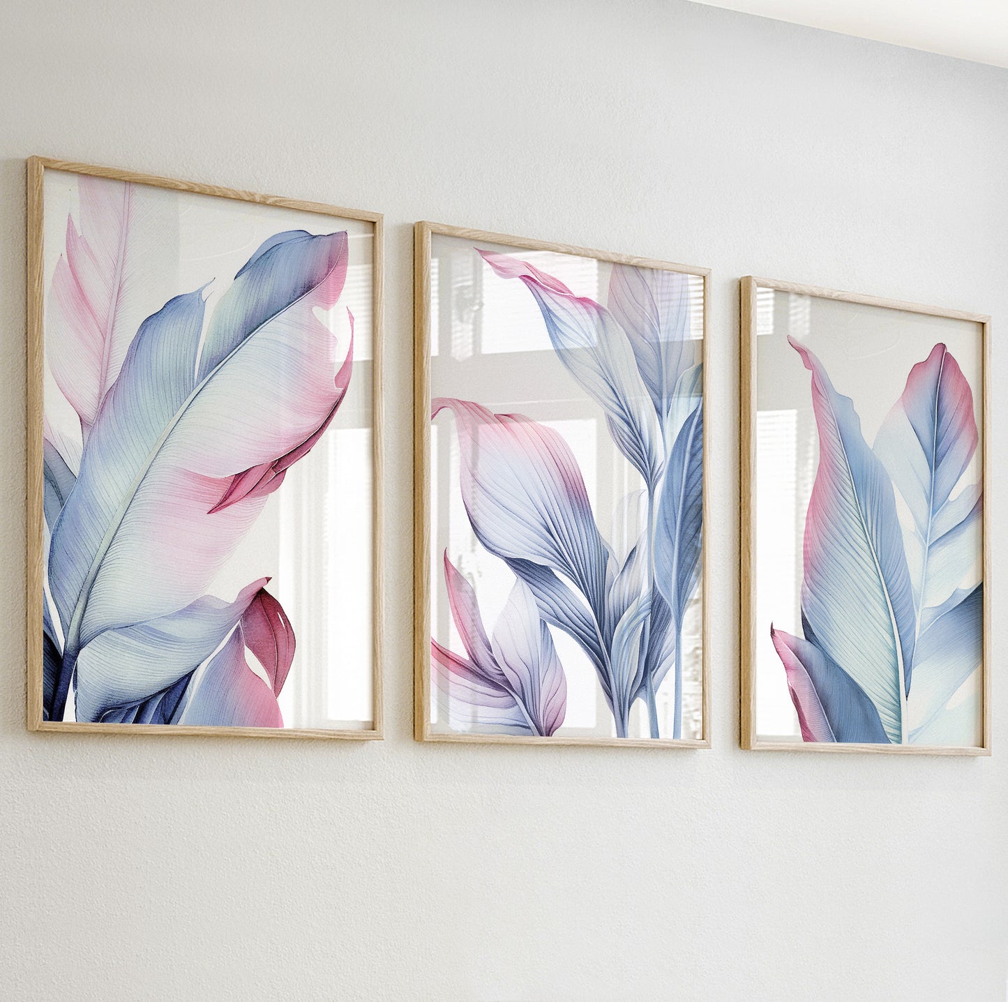 Detailed close-up of a pastel botanical print featuring soft pink and blue tropical leaves in wooden frame.