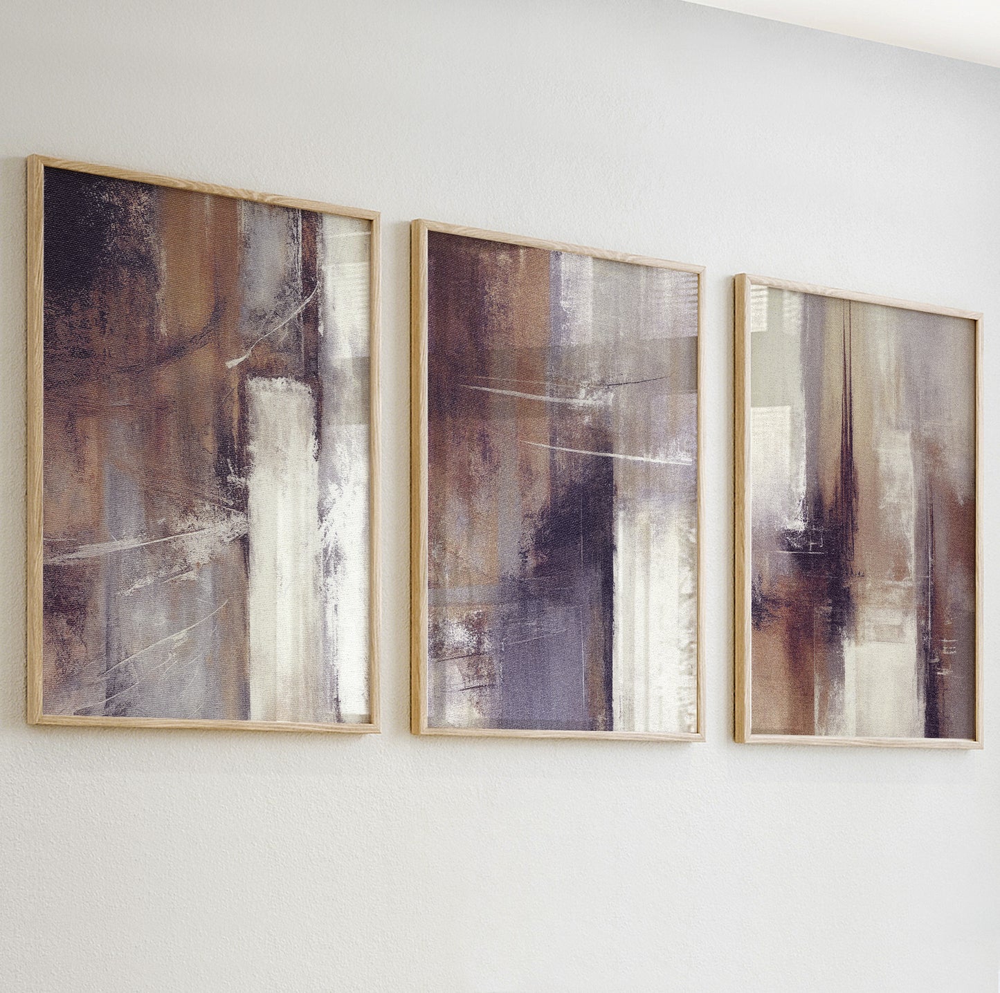 Close-up of textured abstract wall art print in warm beige and taupe tones with soft brushstrokes.