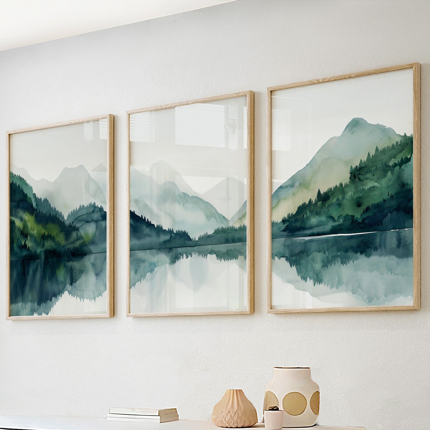 Emerald green nature wall art featuring serene lake in forested mountain valley, minimalist triptych set.