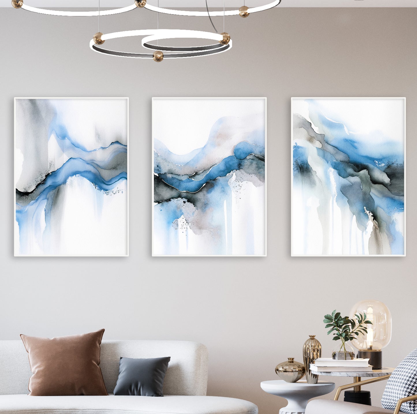 Three abstract art prints reflecting the movement of water in light blues and smoky greys.