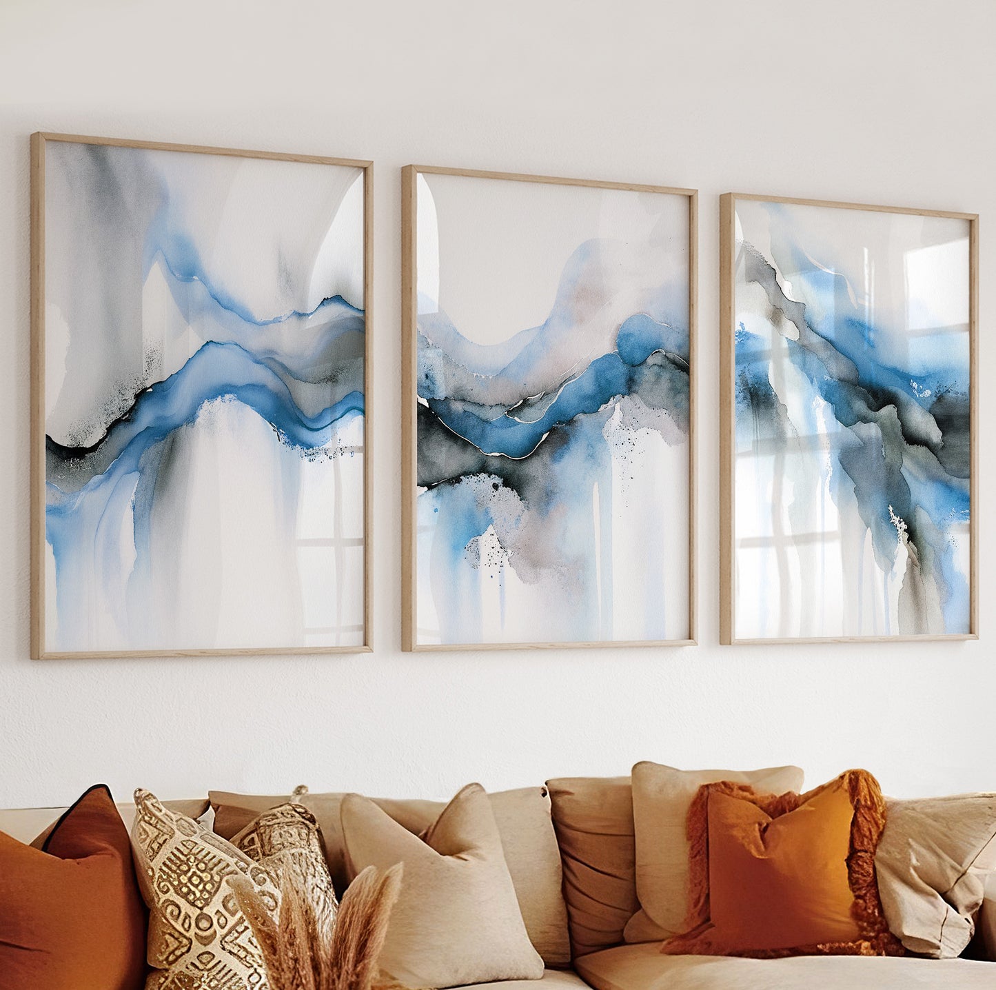 Trio of abstract watercolor-style posters in light blue, grey, and beige for calm interior walls.