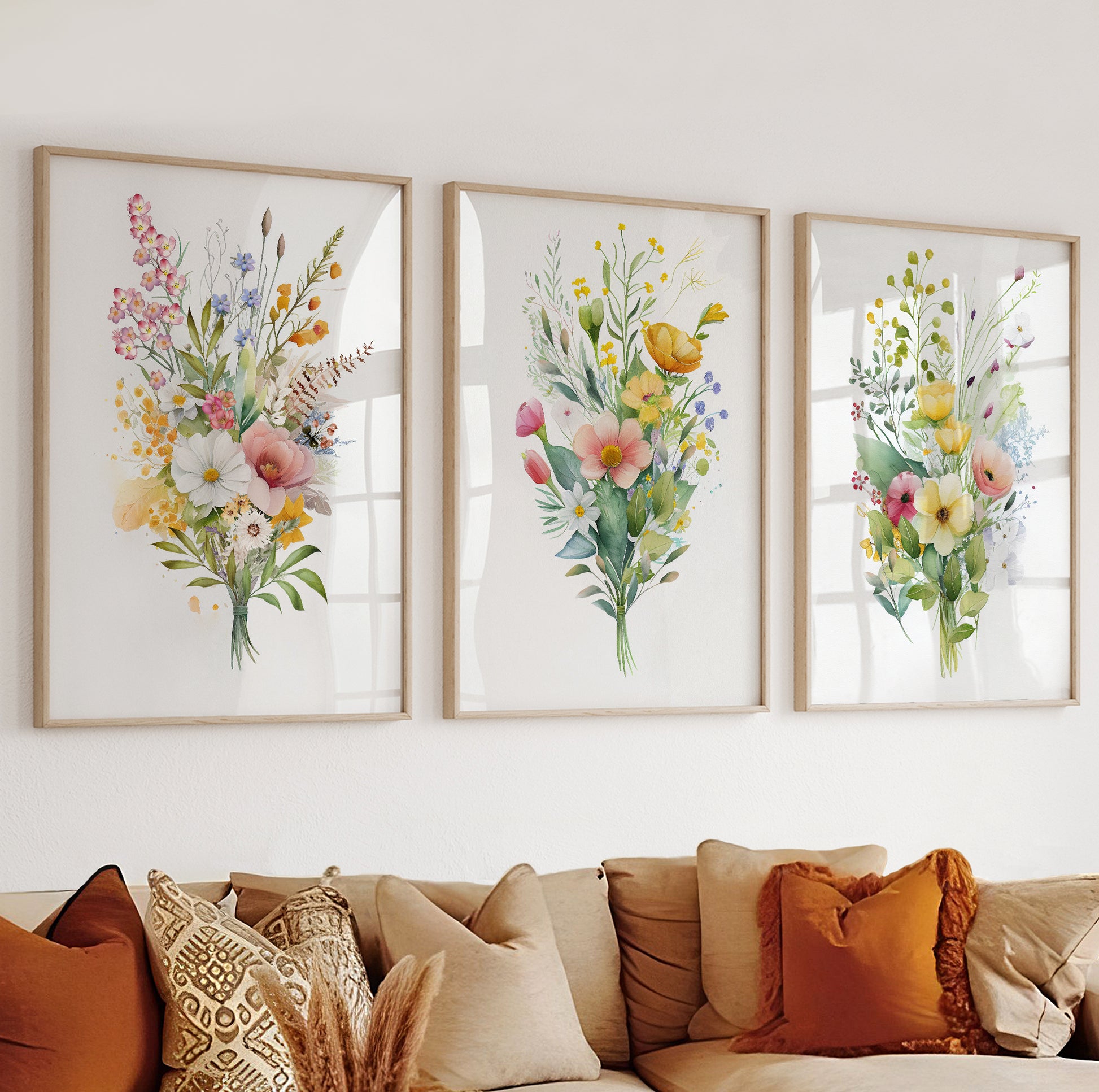 Botanical wall art with pink, yellow, and blue flowers arranged in a soft watercolor composition.

