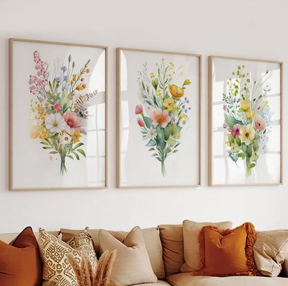 Botanical wall art with pink, yellow, and blue flowers arranged in a soft watercolor composition.

