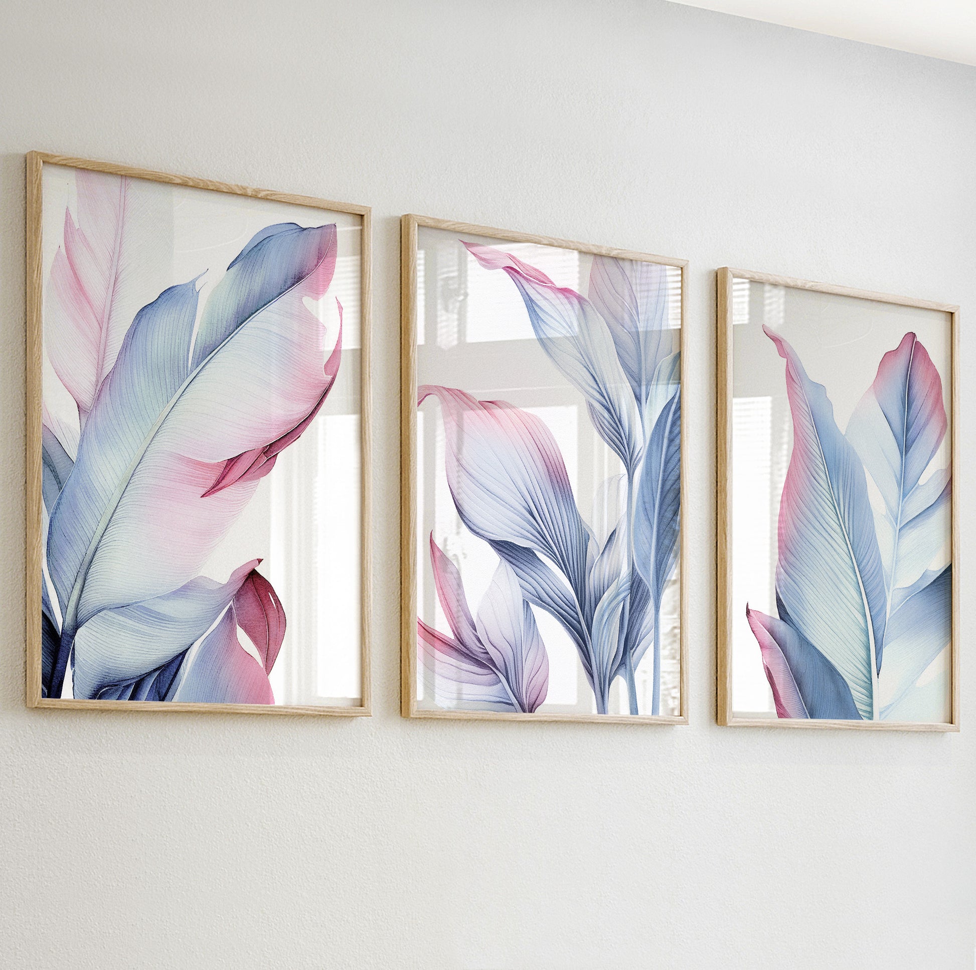 Detailed close-up of a pastel botanical print featuring soft pink and blue tropical leaves in wooden frame.

