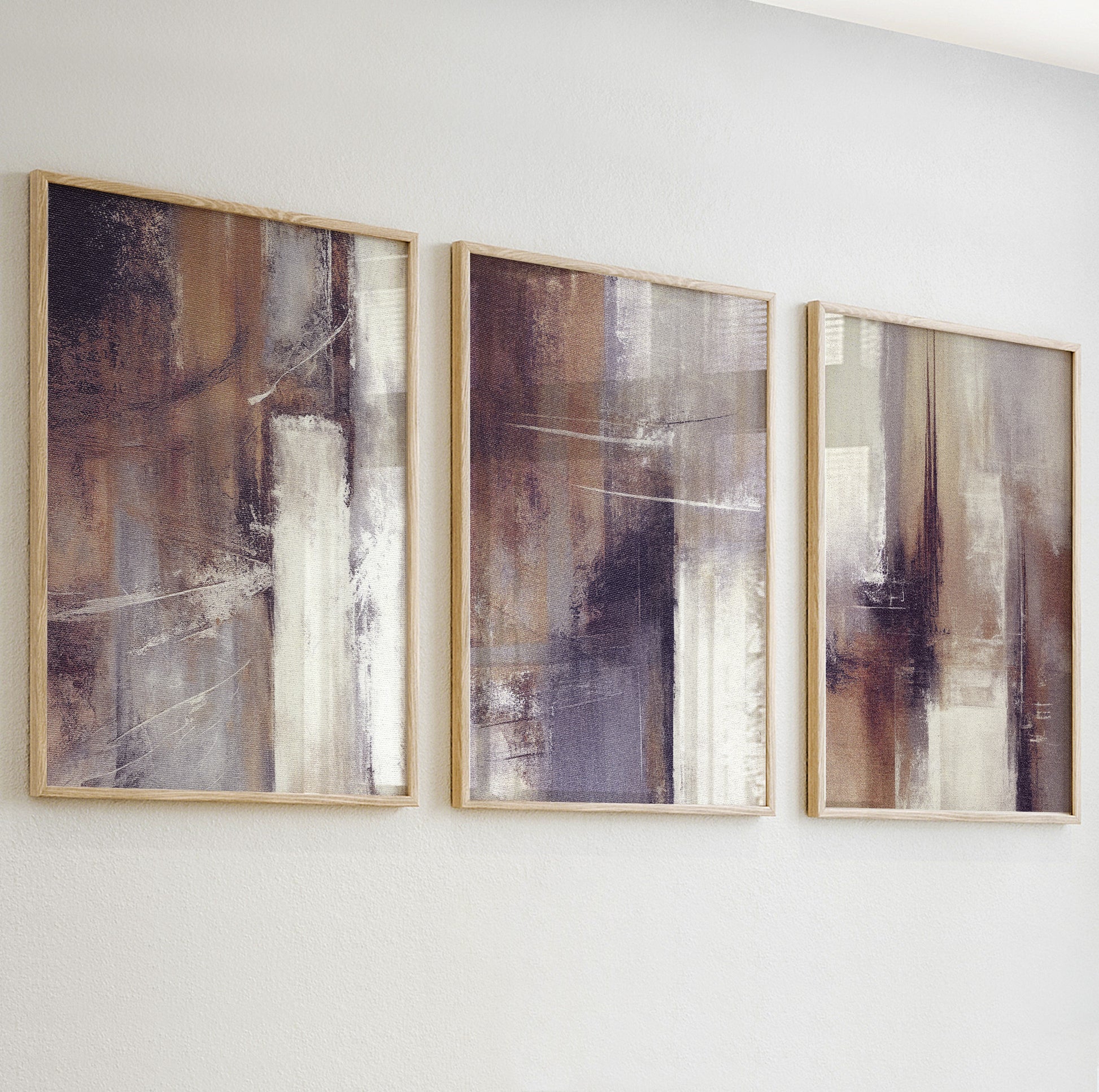 Close-up of textured abstract wall art print in warm beige and taupe tones with soft brushstrokes.


