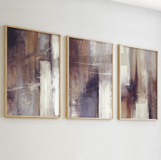 Close-up of textured abstract wall art print in warm beige and taupe tones with soft brushstrokes.

