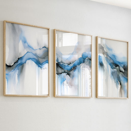 Modern abstract wall print with flowing watercolor shapes in cool blue, grey, and cream tones.

