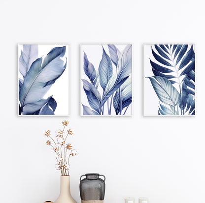 Trio of framed botanical leaf prints in blue tones arranged in a row on a light grey wall, adding harmony to the decor.

